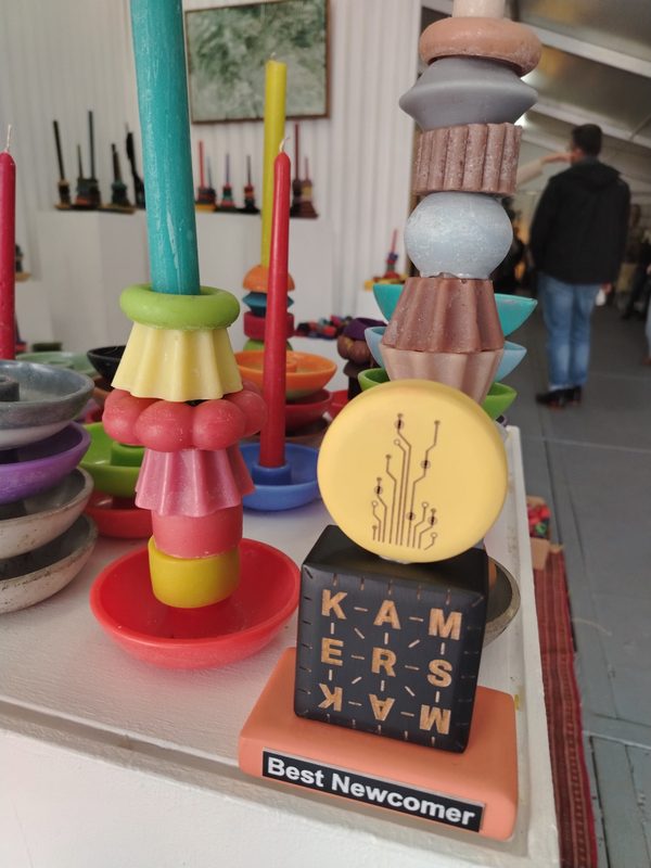 The KAMERS/Makers Best Newcomer award beside a stacked candle